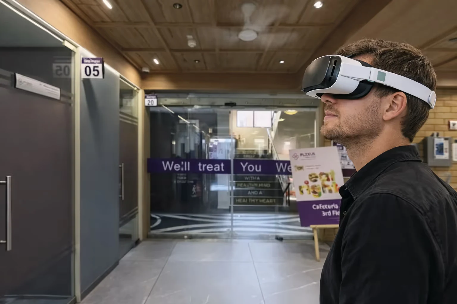 Man wearing a virtual reality headset indoors near glass doors and a sign for a cafeteria.