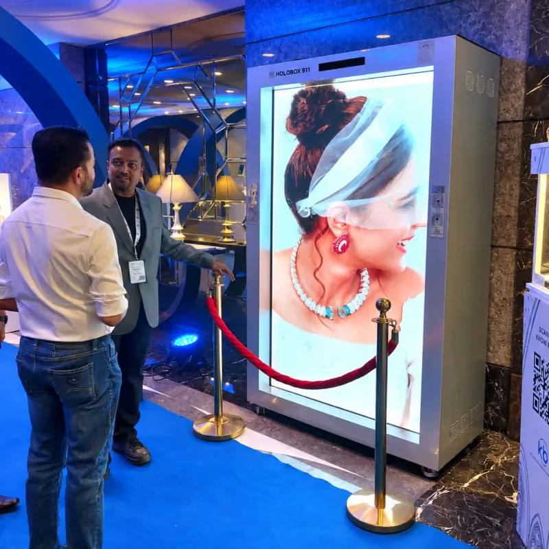 Visitors beside a HoloBox911 display showing jewellery on the show floor at COUTURE INDIA 2026, Taj Palace, New Delhi