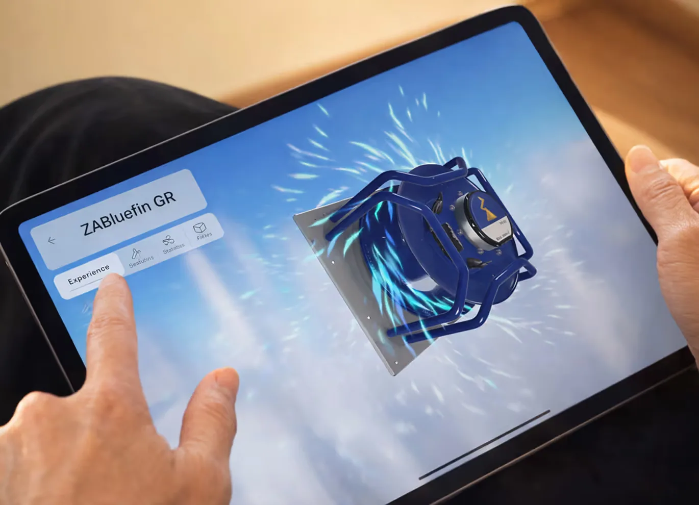 Hand interacting with a tablet showing an interactive 3D exploded view of a "ZABluefin GR" industrial motor assembly in the Sales Enablement App.